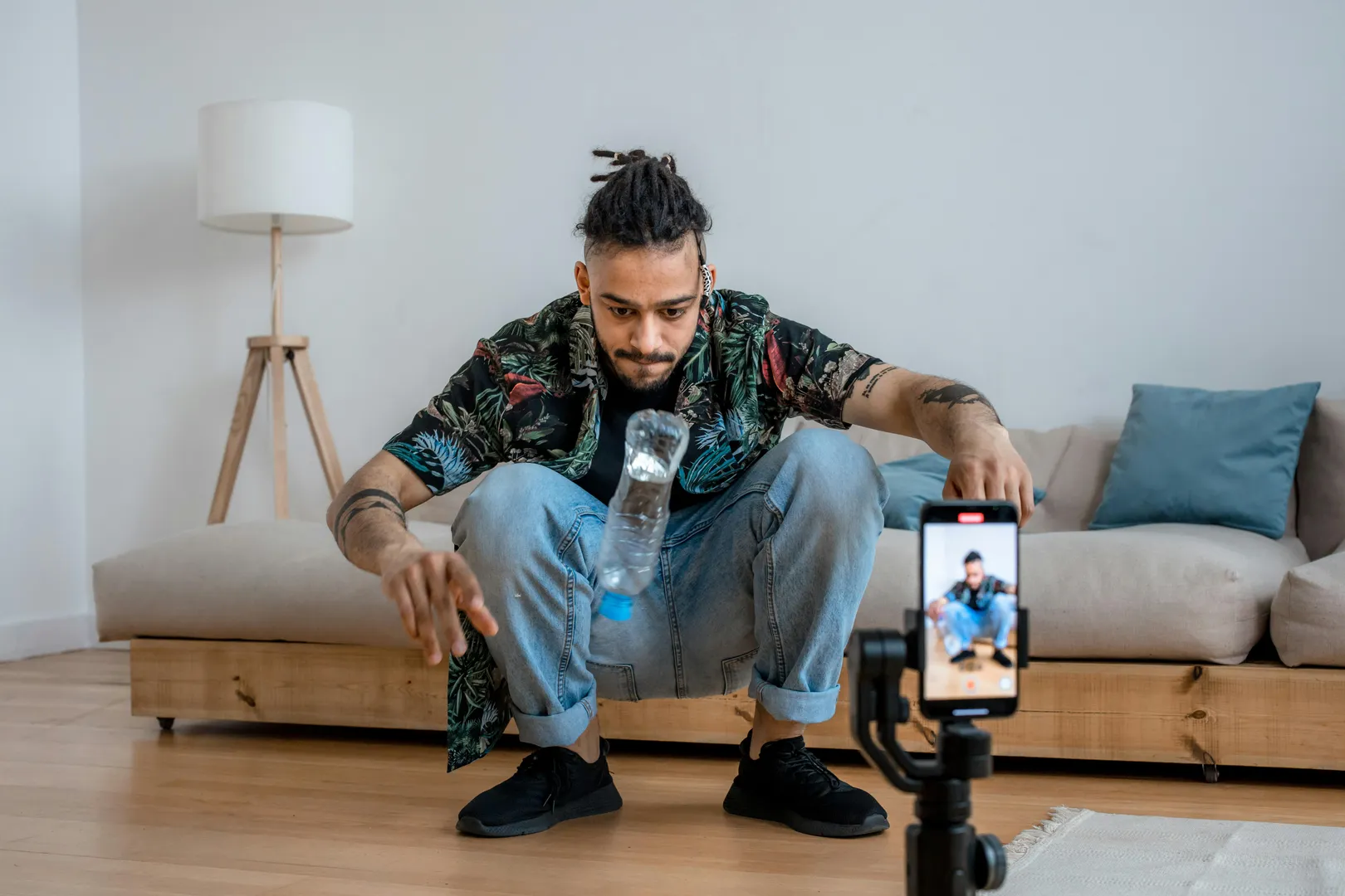 Content creator filming a viral-style TikTok video with smartphone tripod setup