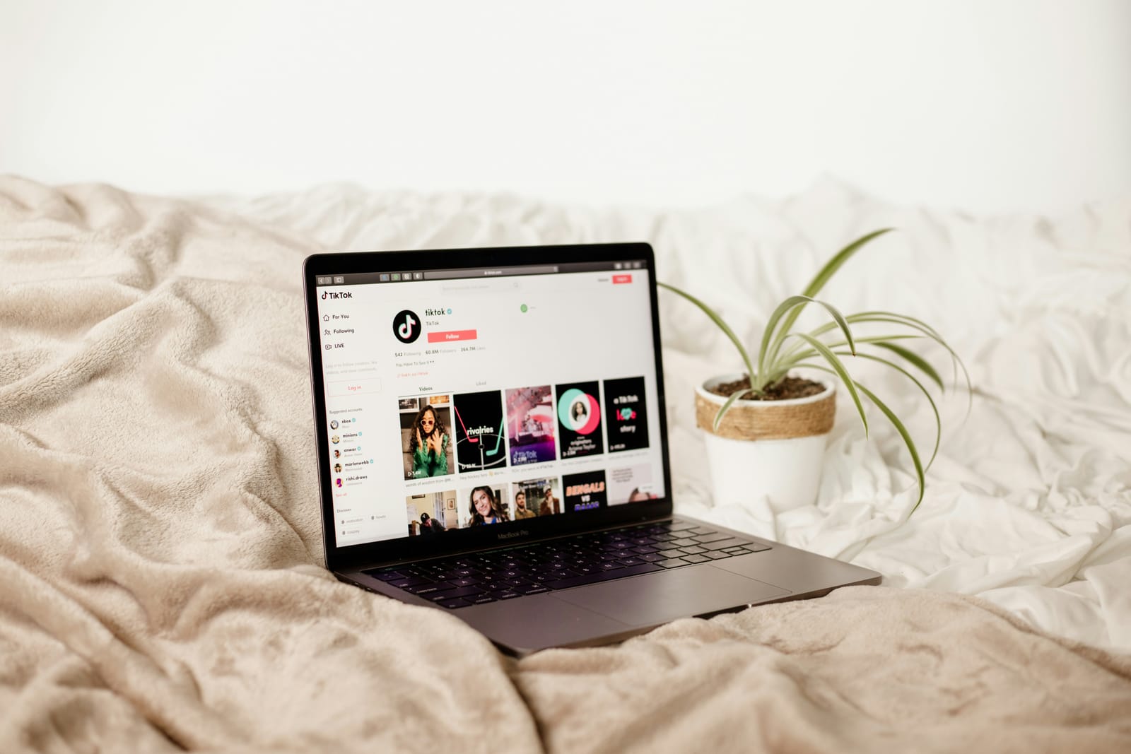 laptop on bed - How to Promote Products on Tiktok